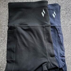 Two pair Women’s Skechers Go Walk capris navy and black